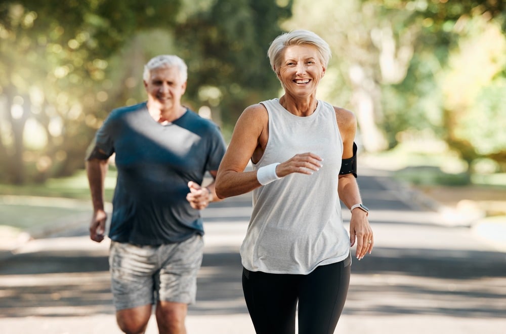 older couple jogging outdoors, embodying a heart smart lifestyle