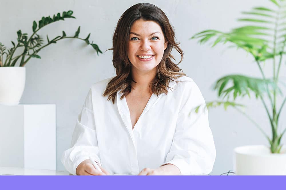 Dietitians_ smiling woman in a white shirt sitting at a desk
